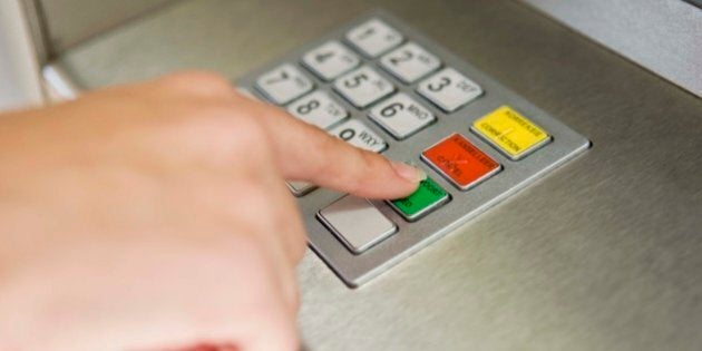 Person pushing buttons of ATM