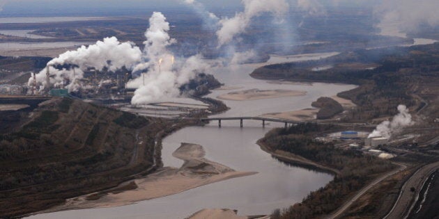 Aerial view of the Suncor oil sands extraction facility on the banks of the Athabasca River and near the town of Fort McMurray in Alberta Province, Canada on October 23, 2009. Greenpeace is calling for an end to oil sands mining in the region due to their greenhouse gas emissions and have recently staged sit-ins which briefly halted production at several mines. At an estimated 175 billion barrels, Alberta's oil sands are the second largest oil reserve in the world behind Saudi Arabia, but they were neglected for years, except by local companies, because of high extraction costs. Since 2000, skyrocketing crude oil prices and improved extraction methods have made exploitation more economical, and have lured several multinational oil companies to mine the sands. AFP PHOTO/Mark RALSTON (Photo credit should read MARK RALSTON/AFP/Getty Images)