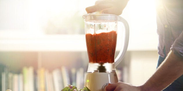 Man making a smoothie at home.