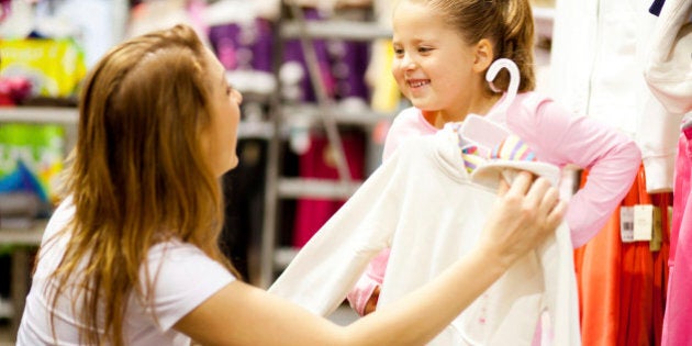 happy mother and daughter shopping for clothes