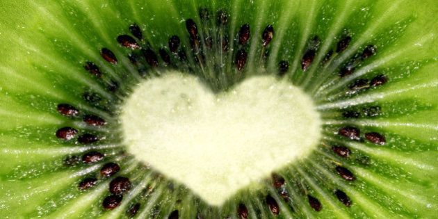 Macro section of kiwi shaped heart with vivid colors.