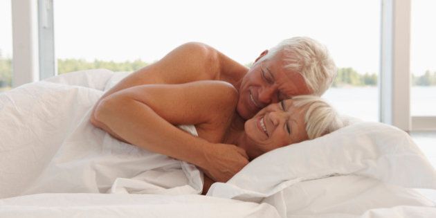 Mature Couple Cuddling In Bed