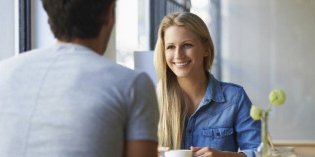 A young couple having coffee at a restaurant