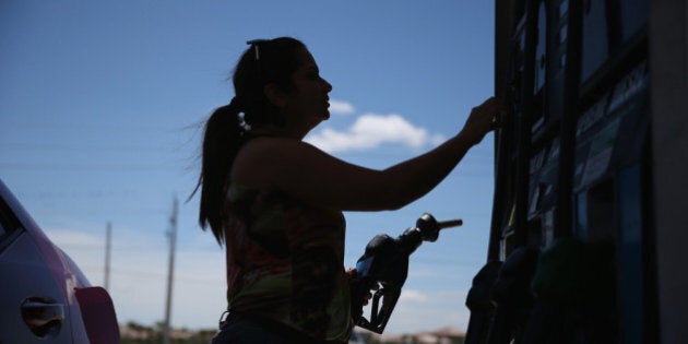 PEMBROKE PINES, FL - APRIL 21: Dora Galeano pumps gas at the Victory gas station on April 21, 2014 in Pembroke Pines, Florida. According to the Lundberg Survey the average price for a gallon of regular gas is now $3.69- the highest price since March of last year. (Photo by Joe Raedle/Getty Images)