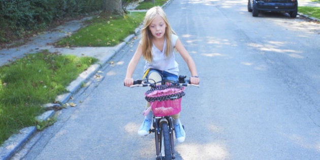 Girl riding her bike in the street