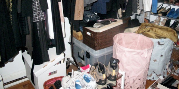 A cluttered closet full of clothes, shoes,accessories.