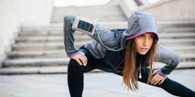 Young woman in sports wear exercising in the morning outdoors at urban scene, with copy space