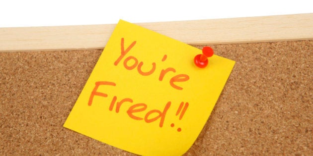 You're fired written on a post it note on a corkboard