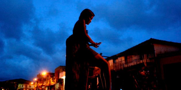 **APN ADVANCE FOR SUNDAY SEPT. 21** A prostitute waits for clients at a street , in Abaetetuba, Para state, Brazil, May 10, 2008. When the Brazilian media discovered that a 15-year-old girl had been locked up for weeks in a cell with 21 men, who only allowed her to eat in return for sex, it set off a national scandal. But it came as little surprise to social workers in this Amazon port city that sits along a major cocaine shipment route, where education is scarce and legitimate work hard to come by. (AP Photo/Renato Chalu)