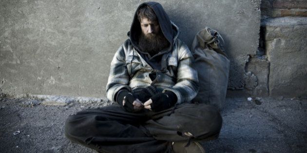 USA, Utah, Salt Lake City, Homeless man with sack sitting on sidewalk