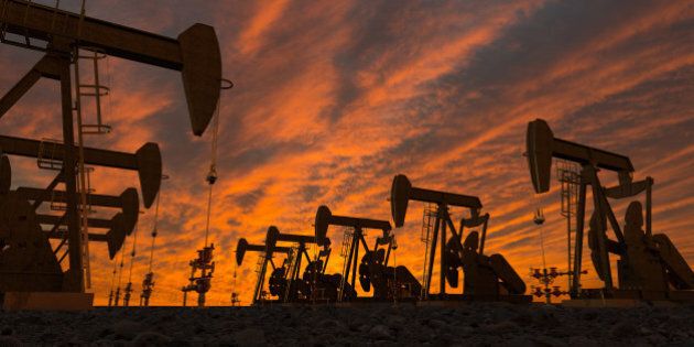 Illustration of pump-jacks on oil field at sunset