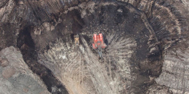 A large power shovel excavates bitumin loaded sand from the Alberta Oilsands near Fort McMurray.