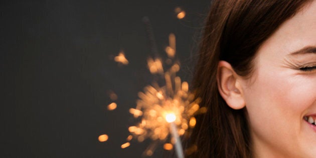 Young woman holding firework