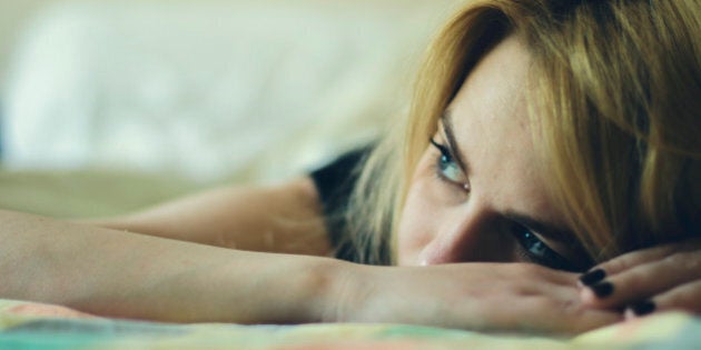 Beautiful woman laying down in a bed