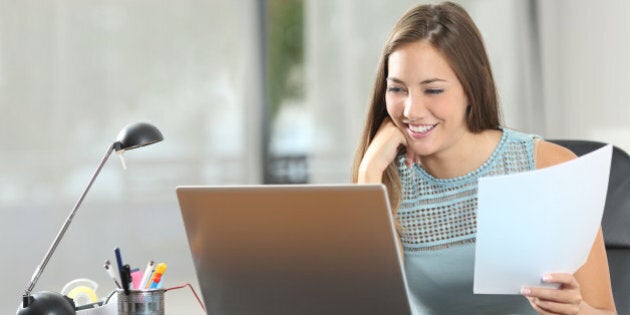 Student studying or entrepreneur working with a laptop and notes at home