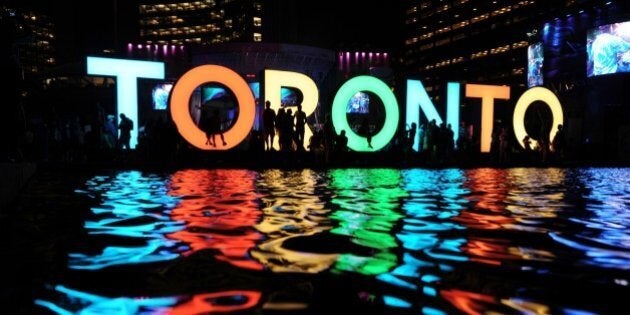 The Toronto sign is seen at the Nathan Phillips Square as people watch a concert during 2015 Pan American Games in Toronto, Canada on July 13, 2015. AFP PHOTO/HECTOR RETAMAL (Photo credit should read HECTOR RETAMAL/AFP/Getty Images)