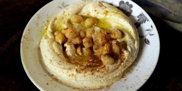 A plate of Hummus is served at a restaurant in the Lebanese coastal city of Tripoli, north of Beirut on October 20, 2014. Hummus is a Levantine food dip or spread made from mashed chickpeas blended with tahini, olive oil, lemon juice, salt and garlic. Today, it is popular throughout the Middle East, North Africa, and in Middle Eastern cuisine around the globe. AFP PHOTO/JOSEPH EID (Photo credit should read JOSEPH EID/AFP/Getty Images)