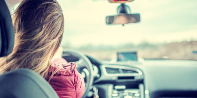 Woman enjoying driving car on her journey