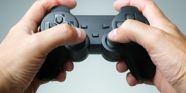 Video game console controller in gamer hands