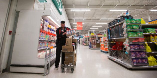 An employee restocks shelves at a grocery store in Lac La Biche, Alberta, Canada, on Saturday, May 7, 2016. Wildfires raging through Alberta have spread to the main oil-sands facilities north of Fort McMurray, knocking out an estimated 1 million barrels of production from Canada's energy hub. Fire officials say the out-of-control inferno may keep burning for months without significant rainfall. Photographer: Darryl Dyck/Bloomberg via Getty Images