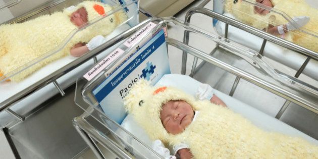 Newborn babies wearing chicken costumes to celebrate the Chinese New Year of Rooster are pictured at the nursery room of Paolo Chockchai 4 Hospital, in Bangkok, Thailand January 27, 2017. REUTERS/Athit Perawongmetha