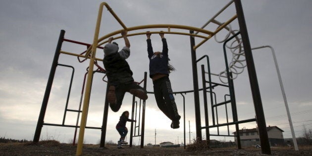 Children play in a playground in the Attawapiskat First Nation in northern Ontario, Canada, April 15, 2016. REUTERS/Chris Wattie