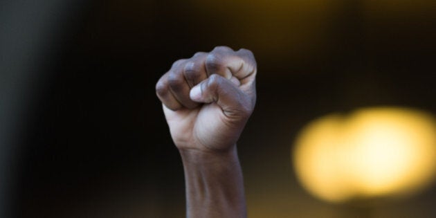 Los Angeles, USA - July 12, 2016 - Black lives matter protestor put their fists in the air as a sign of 'black power' on City Hall following ruling on LAPD fatal shooting of African American female Redel Jones