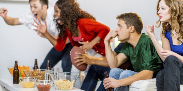 a group of young people watching football game