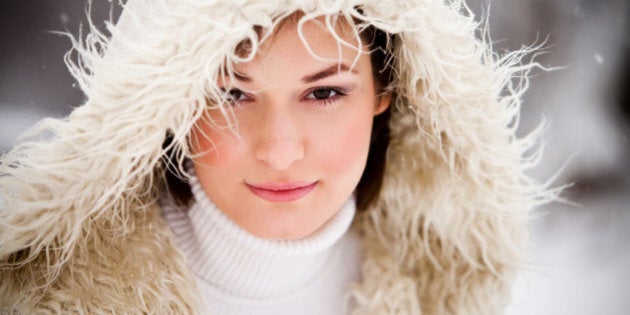 Young girl having fun in snow fall