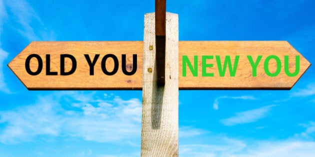 Wooden signpost with two opposite arrows over clear blue sky, Old You and New You, Life change conceptual image