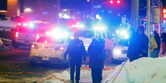 Police officers are seen near a mosque after a shooting in Quebec City, January 29, 2017. REUTERS/Mathieu Belanger