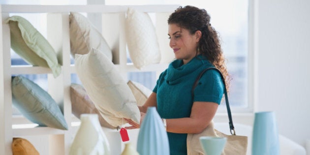 Mixed race woman shopping for pillows