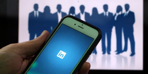 The LinkedIn Corp. logo is displayed on the screens of an Apple Inc. iPhone 6 and a laptop in this arranged photograph taken in London, U.K., on Friday, May, 15, 2015. Facebook Inc. reached a deal with New York Times Co. and eight other media outlets to post stories directly to the social network's mobile news feeds, as publishers strive for new ways to expand their reach. Photographer: Chris Ratcliffe/Bloomberg via Getty Images