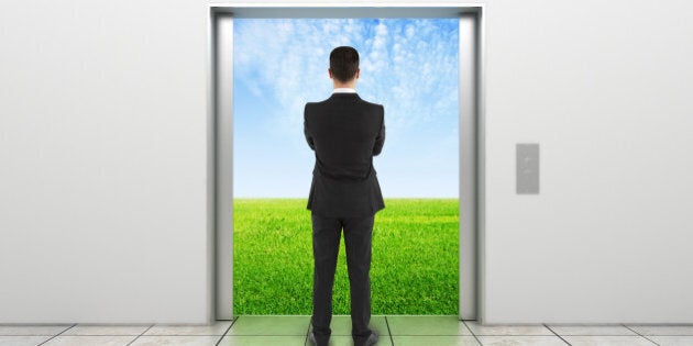 man and modern elevator with opened doors to field