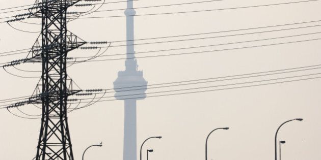 Hydro One power lines cover the view of the CN tower, along with heavy smog, east of downtown Tuesday afternoon. (Photo by Lucas Oleniuk/Toronto Star via Getty Images)