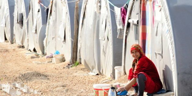 Suruc, Turkey - April 3, 2015: Syrian people in refugee camp in Suruc. These people are refugees from Kobane and escaped because of Islamic state attack.