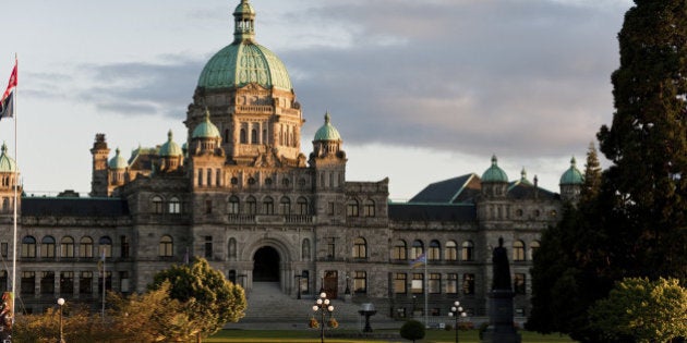 The historic Victoria, BC government building seen at sunset in the inner harbor of this beautiful city.