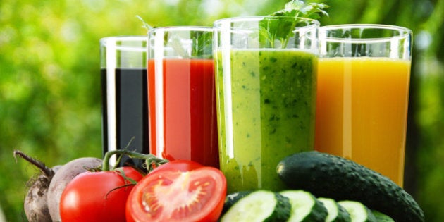 Glasses with fresh vegetable juices in the garden. Detox diet.