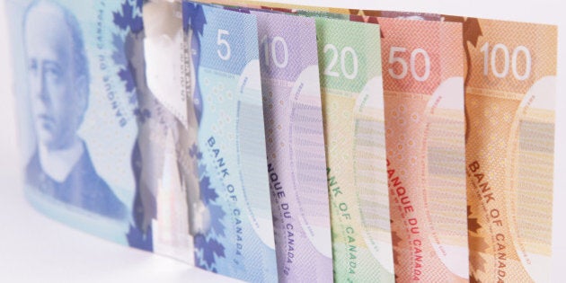 A closeup shot of Canadian currency on a white background with special attention to the reflection of the holographic foil stamping. Good for Canadian financial themes, it illustrates the diversity and colour of Canadian culture.