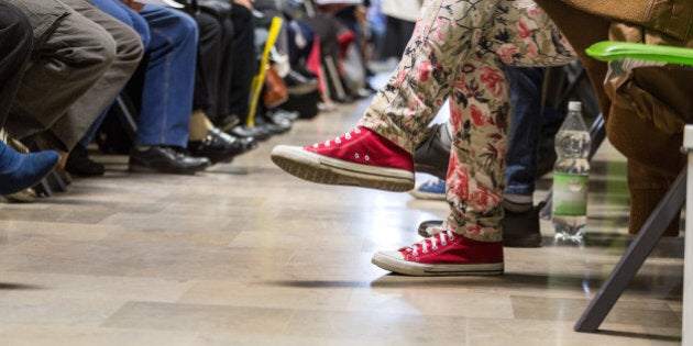 Many people in a waiting room to see a doctor