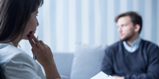 Young female psychiatrist talking with despair patient