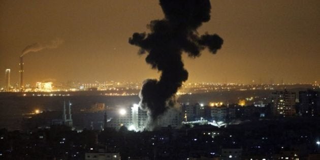 Smoke billows from buildings following an Israeli air strike in Gaza City on July 12, 2014. At least 15 Palestinians were killed in new Israeli strikes on Gaza City late on July 12, 2014, medics in the coastal enclave said. AFP PHOTO /THOMAS COEX (Photo credit should read THOMAS COEX/AFP/Getty Images)