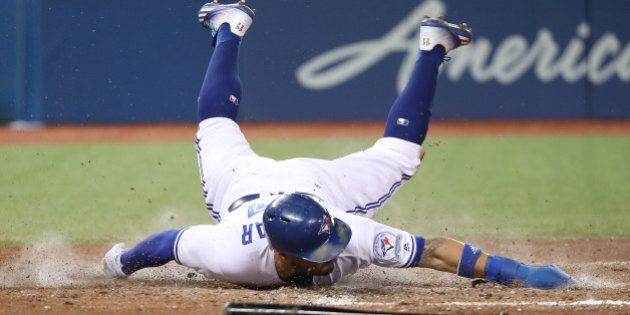 TORONTO, CANADA - SEPTEMBER 27: Kevin Pillar #11 of the Toronto Blue Jays slides across home plate to score a run on an RBI double by Ezequiel Carrera #3 in the fifth inning during MLB game action against the Baltimore Orioles on September 27, 2016 at Rogers Centre in Toronto, Ontario, Canada. (Photo by Tom Szczerbowski/Getty Images)