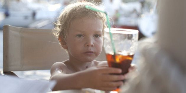child drinking with a straw