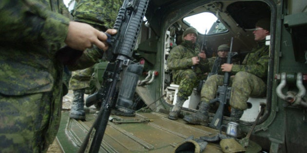 EXERCISE LION ROYAL---11/30/03--Canadian Soldiers clean their weapons prior to going out on patrol in a LAV III. Canadian Forces participate in Exercise Lion Royal in Sherbrooke, PQ, November 30, 2003. In January 2004, the 5 Canadian Mechanized Brigrade Group (5 CMBG) based in Valcartier will go to Kabul to participate in Operation ATHENA. The military is using Sherbooke as a training ground for that exercise. (Photo by Steve Russell/Toronto Star via Getty Images)