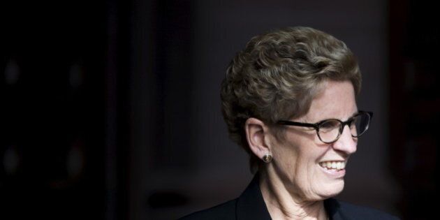 Ontario Premier Kathleen Wynne smiles as she awaits Canada's Prime Minister designate Justin Trudeau to arrive Queen's Park in Toronto, October 27, 2015. REUTERS/Mark Blinch