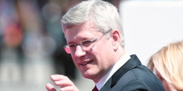 Canada's Prime Minister Stephen Harper waves as he arrives to attend an international D-Day commemoration ceremony on the beach of Ouistreham, Normandy, on June 6, 2014, marking the 70th anniversary of the World War II Allied landings in Normandy. AFP PHOTO / DAMIEN MEYER (Photo credit should read DAMIEN MEYER/AFP/Getty Images)