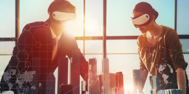 two business persons are developing a project using virtual reality goggles. the concept of technologies of the future