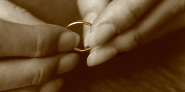 Female hands holding wedding ring