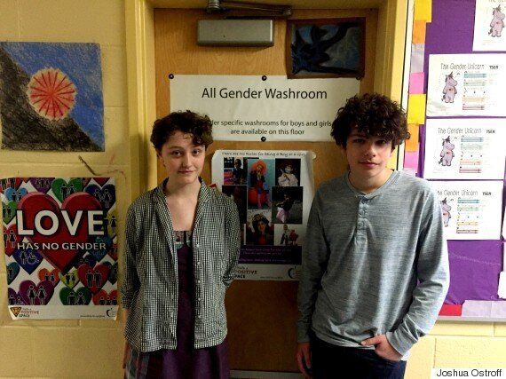 Grade 8 students Odessa Hewitt-Bernhard, left, and Severn Lortie, right, show off City View's pioneering all-gender washroom.